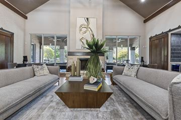 Houston apartment for rent - A living room with a grey couch and a wooden coffee table.