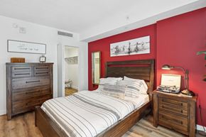 Palmetto Bay apartment for rent - a bedroom with a bed and red walls and wooden furniture