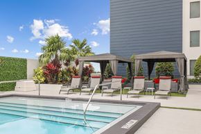Palmetto Bay apartment for rent - a swimming pool with lounge chairs next to a building