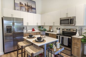 Fitted kitchen with island dining