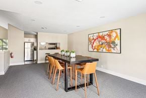 San Antonio apartment for rent - Clubhouse dining area with tall table and seats next to kitchen at Bandera Crossing apartments in San Antonio, TX
