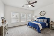 Austin apartment for rent - B3 carpeted bedroom bed, windows, and a ceiling fan at Creekside on Parmer Lane Apartments in Austin, TX