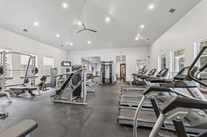 Austin apartment for rent - A fitness center with treadmills, weights, and strength training equipment at Creekside on Parmer Lane Apartments in Austin, TX