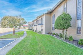 Shreveport apartment for rent - Apartment buildings with second-floor balconies and green grass outside   at The Creole Apartments in Shreveport, LA