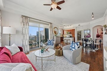 Houston apartment for rent - Model apartment living room with a red couch and a white coffee table at Dominion Post Oak apartments in Houston, TX