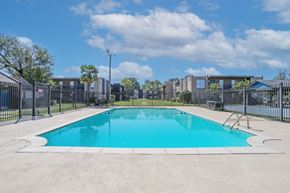 Bossier City apartment for rent - A large outdoor swimming pool surrounded by a fence at The Drake in Bossier City, LA