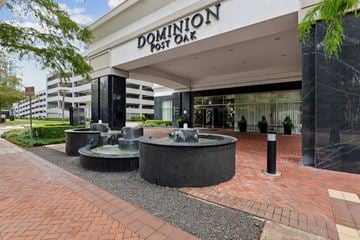 Houston apartment for rent - Dominion Post Bar is a white building with a black fountain in front.