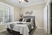 Richardson apartment for rent - Windsor bedroom with carpet, a window, and a ceiling fan at Encore at Buckingham Apartments in Richardson, TX