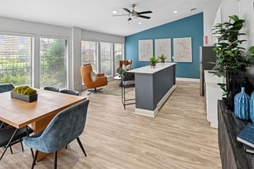 Irving apartment for rent - A modern living room with a wooden table and blue chairs.