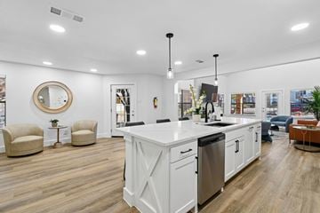 Irving apartment for rent - A modern kitchen with white cabinets and a large island.