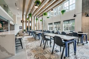 Denton apartment for rent - a large dining room with long tables and chairs and large windows