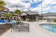 Tallahassee apartment for rent - Poolside lounge chairs at Evergreen at Southwood in Tallahassee, FL