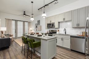 Denton apartment for rent - Model apartment open-concept kitchen and living room quartz countertops at Era apartments in Denton, TX