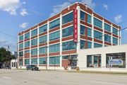 Dallas apartment for rent - a large brick building with a red sign on the side of it