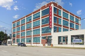 Dallas apartment for rent - a large brick building with a red sign on the side of it