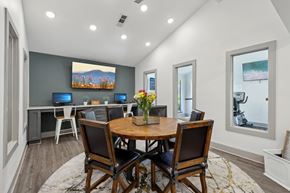 Duluth apartment for rent - A business center with a wooden table and chairs and computers at Gwinnett Square Apartments in Duluth, GA