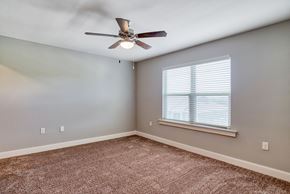 Canton apartment for rent - an empty bedroom with a ceiling fan and a window
