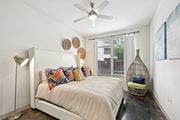 Houston apartment for rent - Model bedroom with a bed and a ceiling fan at Harlow River Oaks in Houston, TX