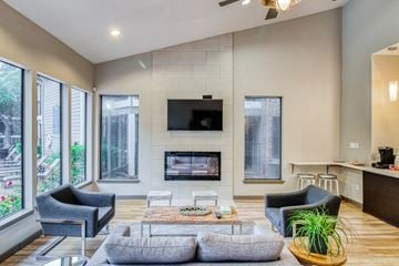 Austin apartment for rent - a living room with a fireplace and a couch and chairs