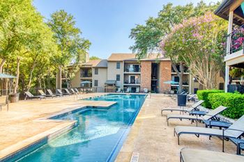 Resort-style swimming pool with expansive tanning deck area