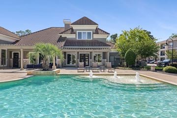 Conroe apartment for rent - A house with a pool in front of it.