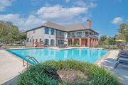 Shreveport triplex for rent - Pool behind the leasing office with poolside seating at Ultris Island Park in Shreveport, LA