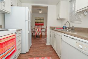 Shreveport apartment for rent - A kitchen with a white refrigerator and a white oven at Laurel Parc apartments in Shreveport, LA.