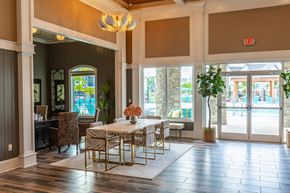 Lakeland apartment for rent - a dining room with a table and chairs in a building with large windows