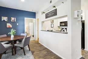 Plano apartment for rent - a dining area with a table and chairs and a kitchen in the background