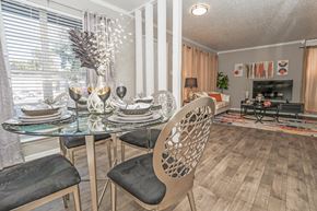 Shreveport apartment for rent - A dining room in our model apartment with a glass table and chairs at Maplewood apartments in Shreveport, LA.