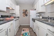 Shreveport apartment for rent - A kitchen with white cabinets and a grey counter top at Maplewood apartments in Shreveport, LA..