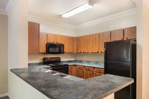 Pensacola apartment for rent - Model kitchen with elevated counter tops and black appliances at Angel Landing Apartment Homes in Pensacola, FL