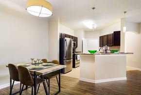 Jacksonville apartment for rent - a dining area with a table and chairs and a kitchen in the background