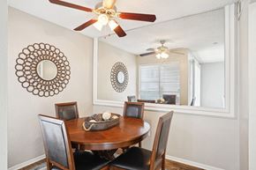 Dallas apartment for rent - Model A2 floor plan dining room with a table and ceiling fan Noel on The Parkway in Dallas, TX