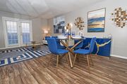 Bossier City apartment for rent - Dining area in the model unit with table and chairs next to living room at The Oasis apartments in Bossier City, LA
