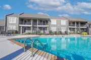 Bossier City apartment for rent - A swimming pool in front of apartment buildings at The Oasis apartments in Bossier City, LA