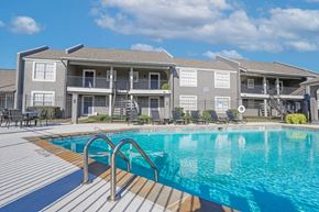 Bossier City apartment for rent - A swimming pool in front of apartment buildings at The Oasis apartments in Bossier City, LA
