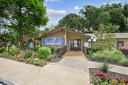 Dallas apartment for rent - A leasing office with a sign in front of it at Preston Oaks Apartments in Dallas, TX.