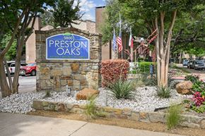 Dallas apartment for rent - An entry sign in front of a stone building at Preston Oaks Apartments in Dallas, TX.
