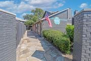 Shreveport apartment for rent - A stone pathway leads to a building with a sign for at "The Pearl" apartments in Shreveport LA