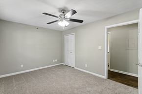 Smyrna apartment for rent - Bedroom with ceiling fan and carpet floors at Oakley Run apartments in Smyrna, GA