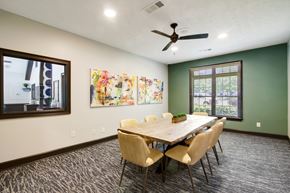 Columbus apartment for rent - a conference room with a table and chairs and a ceiling fan at Grand Reserve at Columbus Apartments in Columbus, Georgia, GA