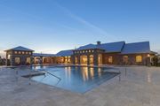 Titusville apartment for rent - a swimming pool in front of a house with a blue sky