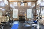 Titusville apartment for rent - a gym with weights and exercise equipment in a building with wooden walls