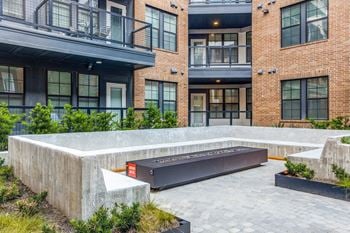 Serene courtyard with firepit, water fountain & outdoor cafe