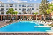 Houston apartment for rent - A large swimming pool in front of a multi-story apartment building at The Grand At Upper Kirby in Houston, TX