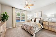 Houston apartment for rent - Bright bedroom with ceiling fan and large window at The Grand at Upper Kirby apartments in Houston, TX