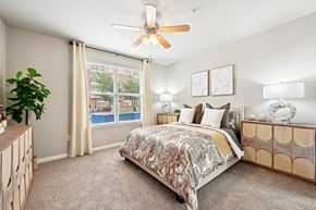 Houston apartment for rent - Bright bedroom with ceiling fan and large window at The Grand at Upper Kirby apartments in Houston, TX