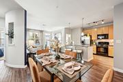 Houston apartment for rent - Stylish dining area and modern kitchen with pendant lighting at The Grand at Upper Kirby apartments in Houston, TX