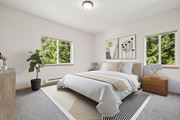 Olympia apartment for rent - Master bedroom virtually staged with a large bed and a potted plant in the Jackson floor plan at The Madison apartments in Olympia, WA